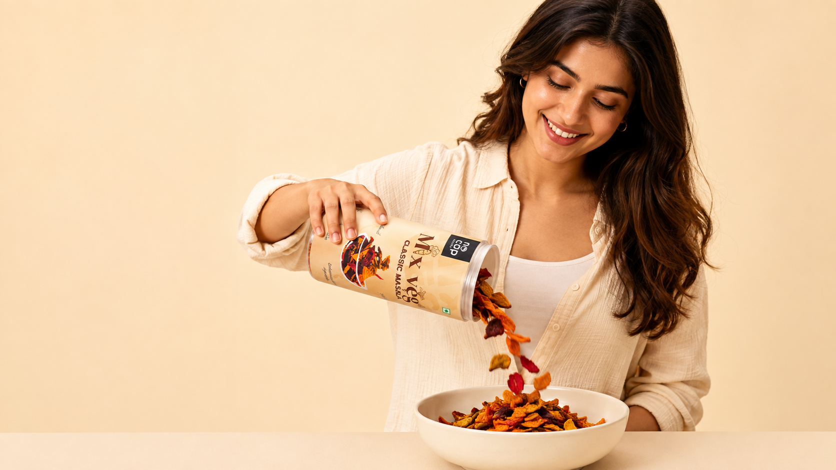 Person pouring NoCap snacks from a canister into a bowl